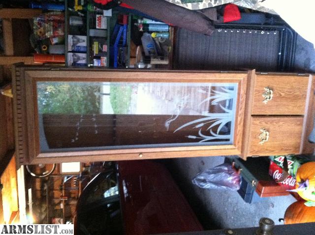 Wood gun cabinet with duck scene etched in the glass door. Has storage 